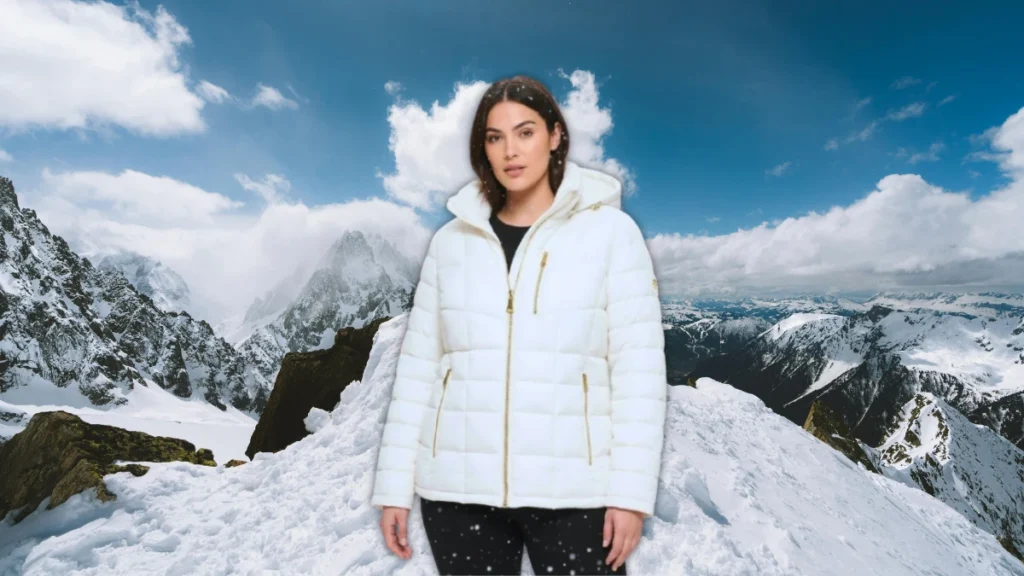 A woman wearing a black Calvin Klein hooded puffer jacket with faux fur trim from Macy's Winter 2026 collection.