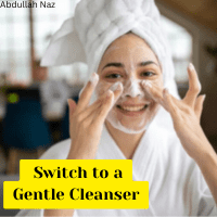 Winter Skincare Secrets 10 Ways to Keep Your Skin Smooth and Hydrated 3
A person with dark hair, wrapped in a white towel on their head and a white robe, smiles while applying a white foamy cleanser to their face with both hands. There's a yellow box at the bottom with the text "Switch to a Gentle Cleanser". The name "Abdullah Naz" is faintly visible in the top left corner.