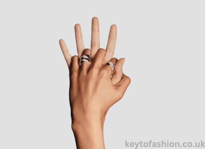 The Coco Crush A Symbol of Power and Modern Luxury, Redefined 3 Hands intertwined, showcasing a collection of sparkling rings.