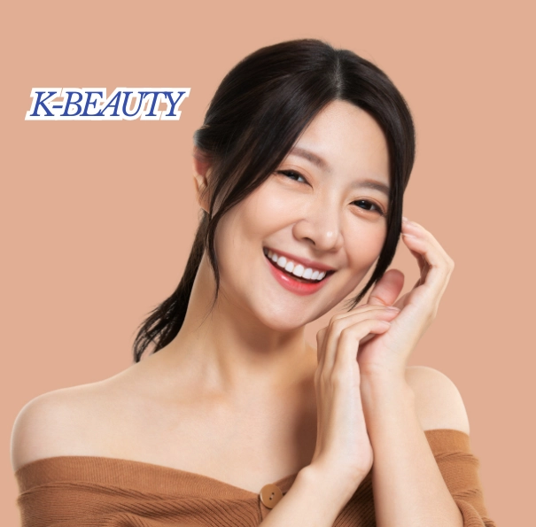 Discover K-Beauty 2025 Unlock Stunning Trends Everyone Loves! 2 A promotional image for K-Beauty featuring a joyful young East Asian woman with dark hair tied back and a bright smile. She is wearing a brown off-the-shoulder top and holding her hands near her face against a solid peach background.