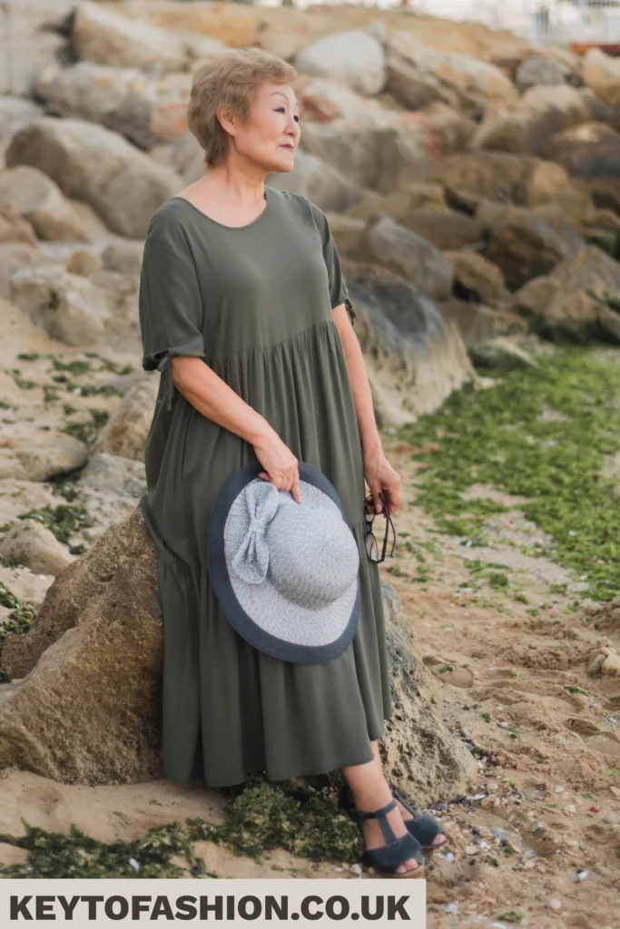 How to Master Styling a Boho Maxi Dress Floral Look The Secret to Natural Polished Dressing 2 Woman Boho Maxi Dress in green dress holding hat.