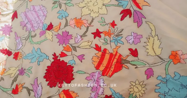 Why High-Quality Hand Embroidery Is Your Best Investment 8 Hand Embroidered Style close up view of colorful Kashmiri Aari embroidery on beige fabric